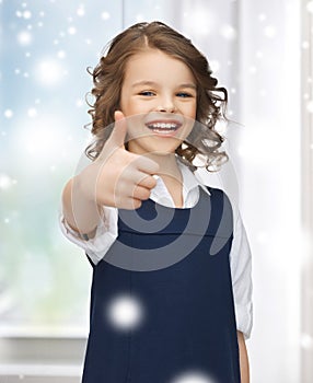 Pre-teen girl showing thumbs up