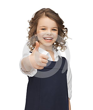 Pre-teen girl showing thumbs up