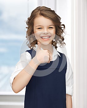 Pre-teen girl showing thumbs up