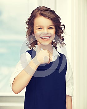 Pre-teen girl showing thumbs up
