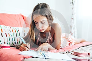 Pre teen girl writing diary