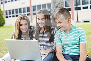 Pre-teen School Pupils Outside of the Classroom with laptop