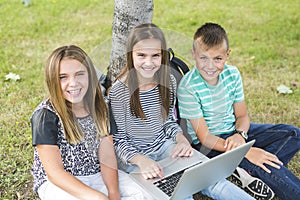 Pre-teen School Pupils Outside of the Classroom with laptop
