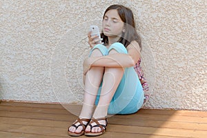 Pre teenager girl texting on mobile phone