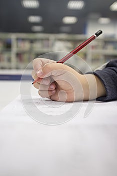 Pre-writter child boy doing calligraphy exercises with booklets