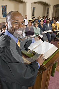 Preacher at altar with Bible preaching to Congregation portrait