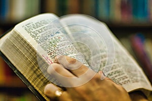 Preacher holds a King James version Bible