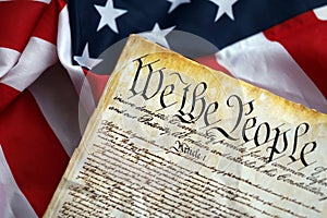 Preamble to the Constitution of the United States and American Flag close up