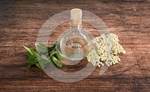 Preaparation for home made Elderberry syrup. Home made with sugar, and lemons. On the wooden background.