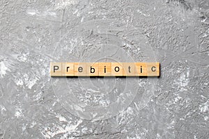 Prebiotic word written on wood block. prebiotic text on table, concept