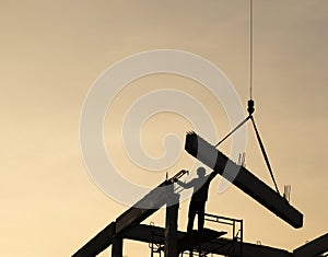 precast concrete beam intralled at construction site by mobile crane