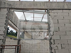 Precast concrete lintels are installed on wall openings such as doors and windows to support the bricks above.