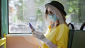 Precautions, female passenger wearing a medical mask and gloves to protect against virus and infection listening to