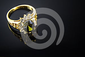 Precious gems and gold ring in black