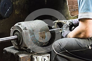 Precious parts polishing machine, Man polishing a jewel. photo