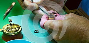 Precious pocket watch disassembled on the clockmaker work table