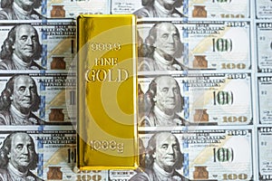 Precious shiny gold bar on dollar bills. gold reserve of the United States of America