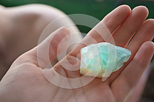 Precious stone, magic blue cristal in hand, mineral