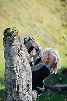 Precise devoted senior artist carving in stone