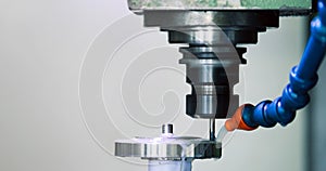 Precision industrial CNC machining of metal detail by mill at factory