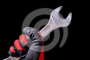 Precision in Motion: Chrome Wrench Tool in Hand with Protective Gloves - Mechanical Mastery