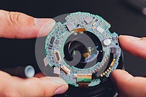 Precision prime optical dslr lens service, adjustment and alignment. Camera lens repair set in photo engineer workplace