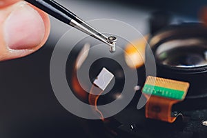 Precision prime optical dslr lens service, adjustment and alignment. Camera lens repair set in photo engineer workplace