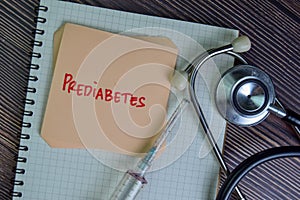 Prediabetes write on sticky notes isolated on Wooden Table