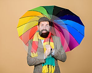 Predict future weather trends. Man bearded guy hold colorful umbrella. It seems to be raining. Rainy days can be tough