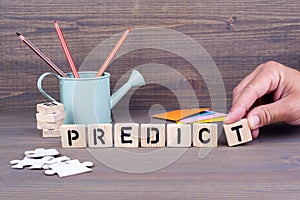 Predict. Wooden letters on dark background photo