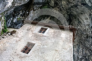Predjama castle in Slovenia. Castle interior, room with old equipment and furniture. Barrels and lahe with wine.