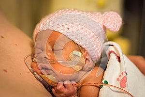 Preemie baby girl enjoying skin to skin with dad