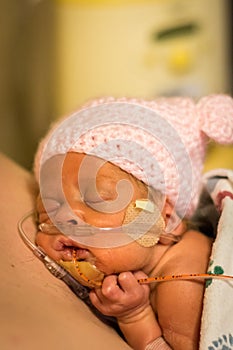 Preemie baby girl enjoying skin to skin with dad