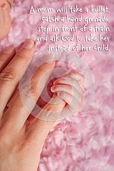 Preemie holding mother's finger with inspirational quote