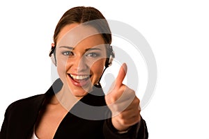 Preety happy asian caucasian business woman with headset showing