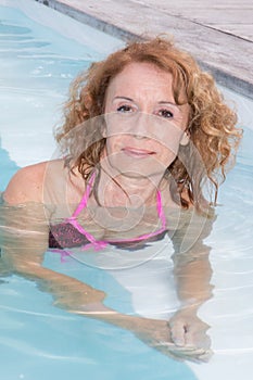 Preety middle aged woman in bikini in pool