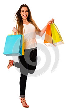 Preety young woman with colorful shopping bags isolated over white background