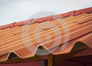 Prefabricated orange tile roof in simple house construction.