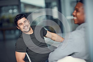 We prefer our meetings to be relaxed. two young businessmen having a meeting in a modern office.