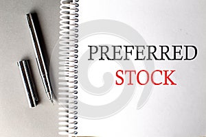 PREFERRED STOCK text on a notebook with pen on grey background