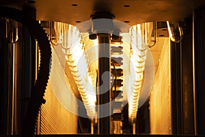 The  preform shape of plastic bottles  in the conveyor belt  for heating process.