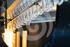 The  preform shape of plastic bottles  in the conveyor belt  for heating process.