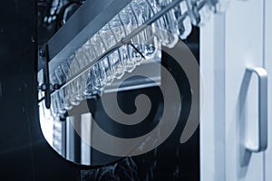 The  preform shape of plastic bottles  in the conveyor belt  for heating process.