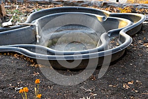 Preformed plastic pond with frozen water.