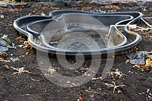 Preformed plastic pond with frozen water.