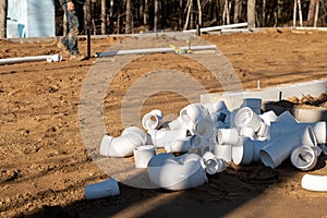 Preformed plastic or PVC elbows on dirt at construction site