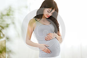 Pregnancy. Beautiful Smiling Pregnant Woman