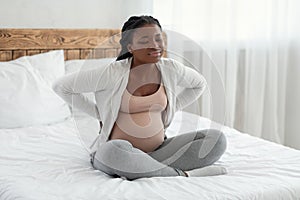 Pregnancy Complications. Black Expectant Mother Suffering Lower Back Pain At Home