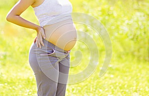 Pregnancy concept, the expectant mother outdoors