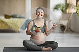 Pregnancy Diet. Happy Pregnant Young Woman Eating Fresh Vegetable Salad At Home